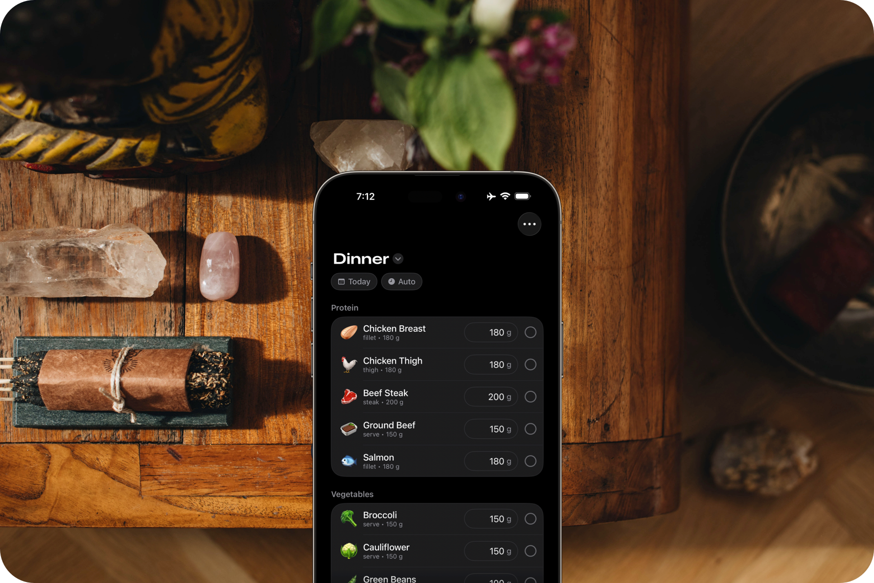 A hand holding an iPhone displaying a custom space for dinner